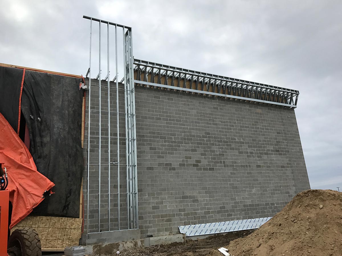 Steel framing rising over the masonry wall at the PetSmart site
